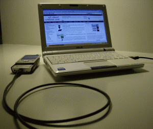 A mobile phone connected to a laptop computer. Image courtesy allaboutsymbian.com