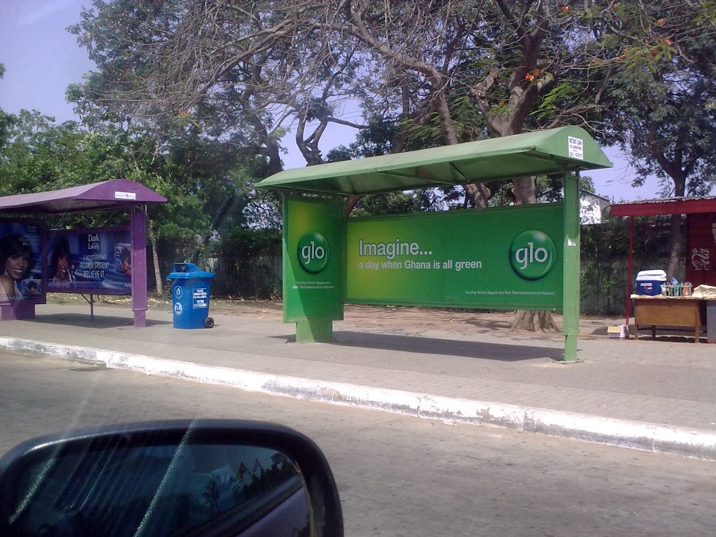 A Glo-branded bus stop in Accra reading: 'imagine... a day when Ghana is all green'. Photo by Oluniyi David Ajao