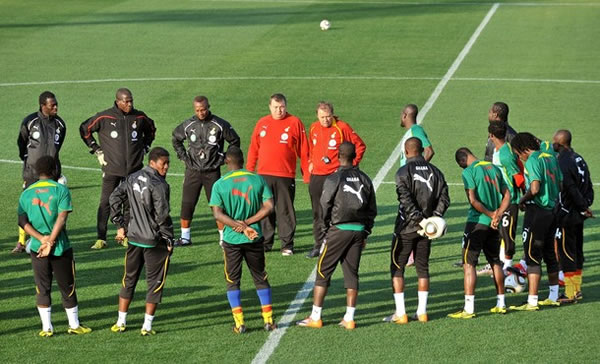 Ghana's head coach Milovan Rajevac (centre R-in red) and his players gather during a training session at Mogwase stadium in Mogwase, north of Rustenburg, on June 10, 2010 ahead of the start of the 2010 World Cup football tournament.
