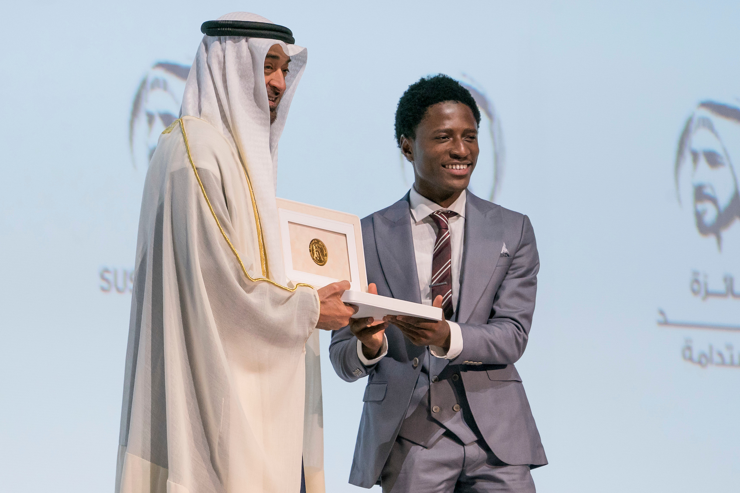 ABU DHABI, UNITED ARAB EMIRATES - January 13, 2020: HH Sheikh Mohamed bin Zayed Al Nahyan, Crown Prince of Abu Dhabi and Deputy Supreme Commander of the UAE Armed Forces (L), presents an award to a representative from ‘Okuafo’, the winners of the Zayed Sustainability Prize for Food.  (Mohamed Al Hammadi / Ministry of Presidential Affairs)