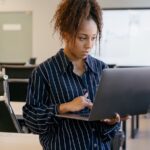 Woman working on a laptop in an office