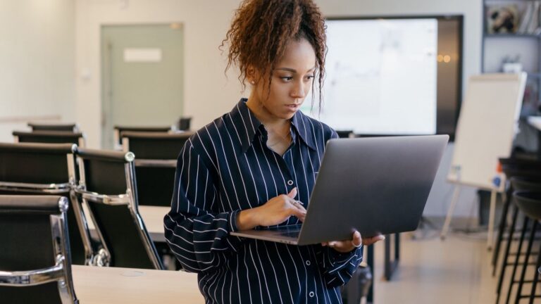 Woman working on a laptop in an office