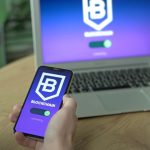 A hand holding a smartphone displaying blockchain and cryptocurrency data