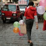 Shoppers walking through a busy street market in Cairo