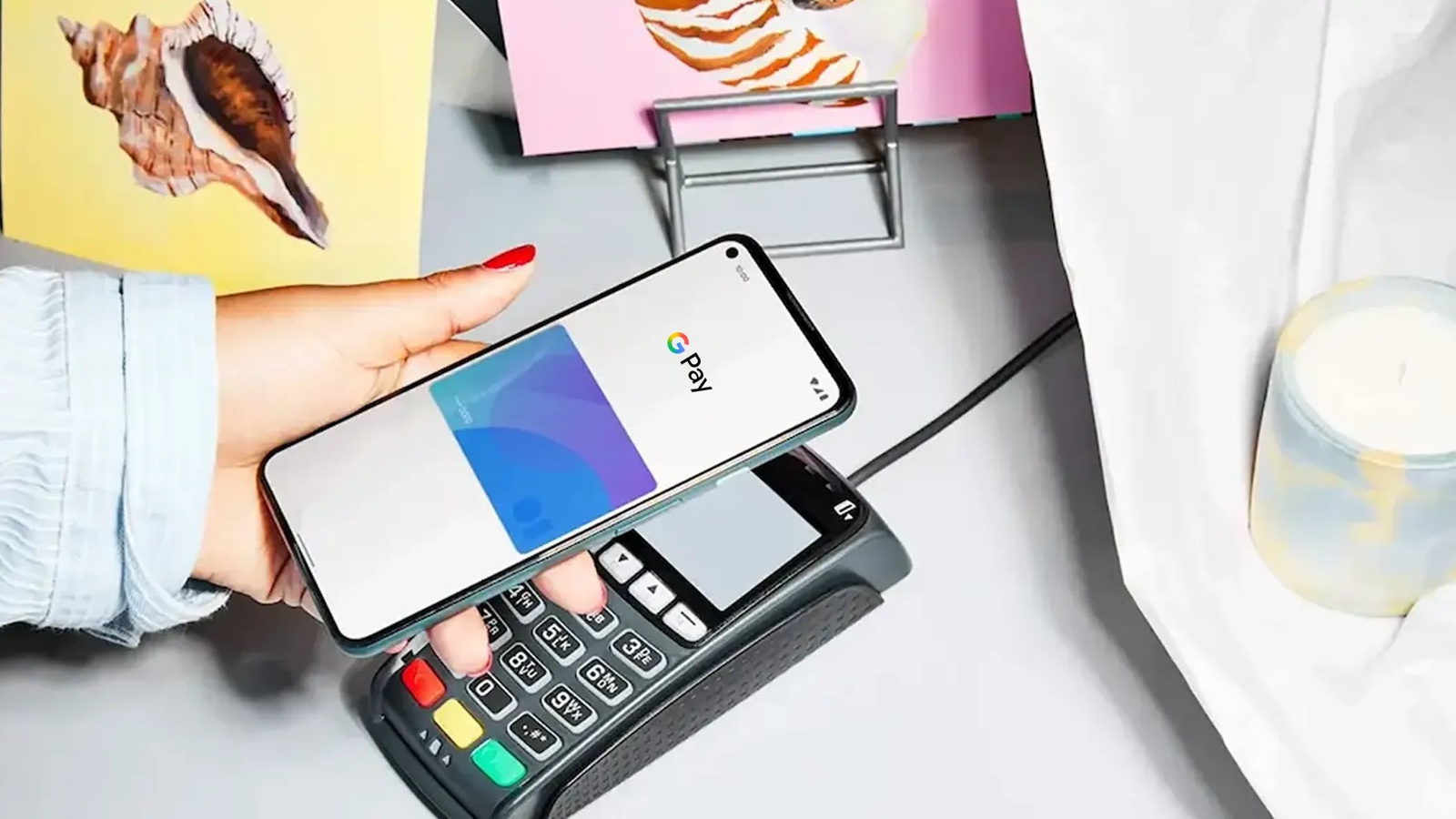 GTBank cards and Squad checkout go live with Google Pay 1 Hand holding an Android phone showing Google Pay above a card payment terminal