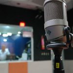 Microphone and mixing desk in a radio broadcast studio