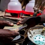 Naira banknotes and a mobile phone, illustrating mobile money