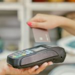 Customer paying with a bank card at a point-of-sale terminal
