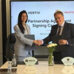 Vertiv's Zineb Kamri shakes hands with Cybastion's Scott Blacklin after signing a data centre partnership in Marrakech, Morocco.