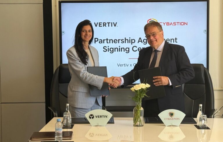 Vertiv's Zineb Kamri shakes hands with Cybastion's Scott Blacklin after signing a data centre partnership in Marrakech, Morocco.
