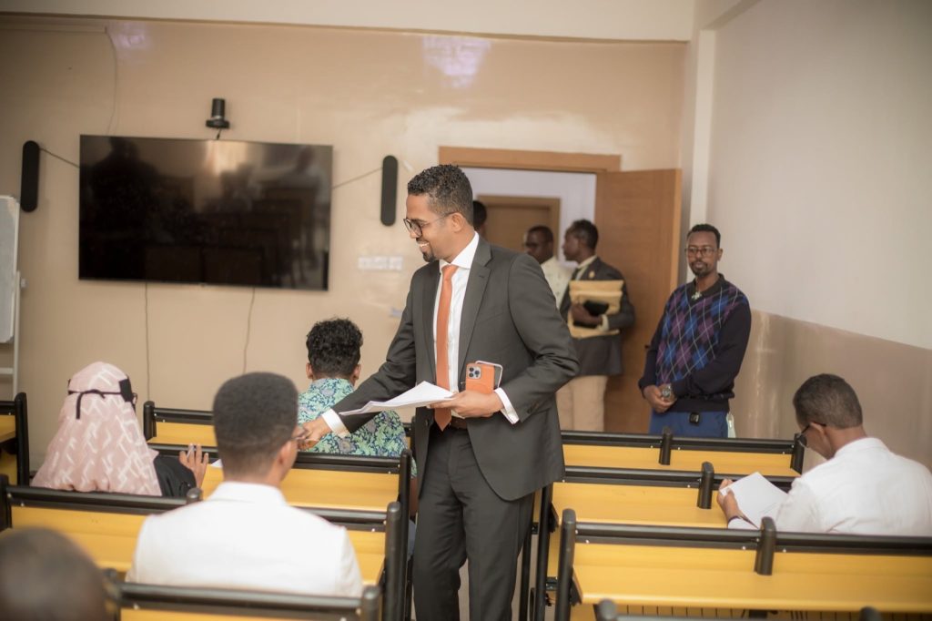 Q&A: building a digital Islamic bank in Somaliland 18 Candidates sit a written recruitment examination in a lecture hall as a Wadaag Bank staff member hands out papers, in Hargeisa, Somaliland.