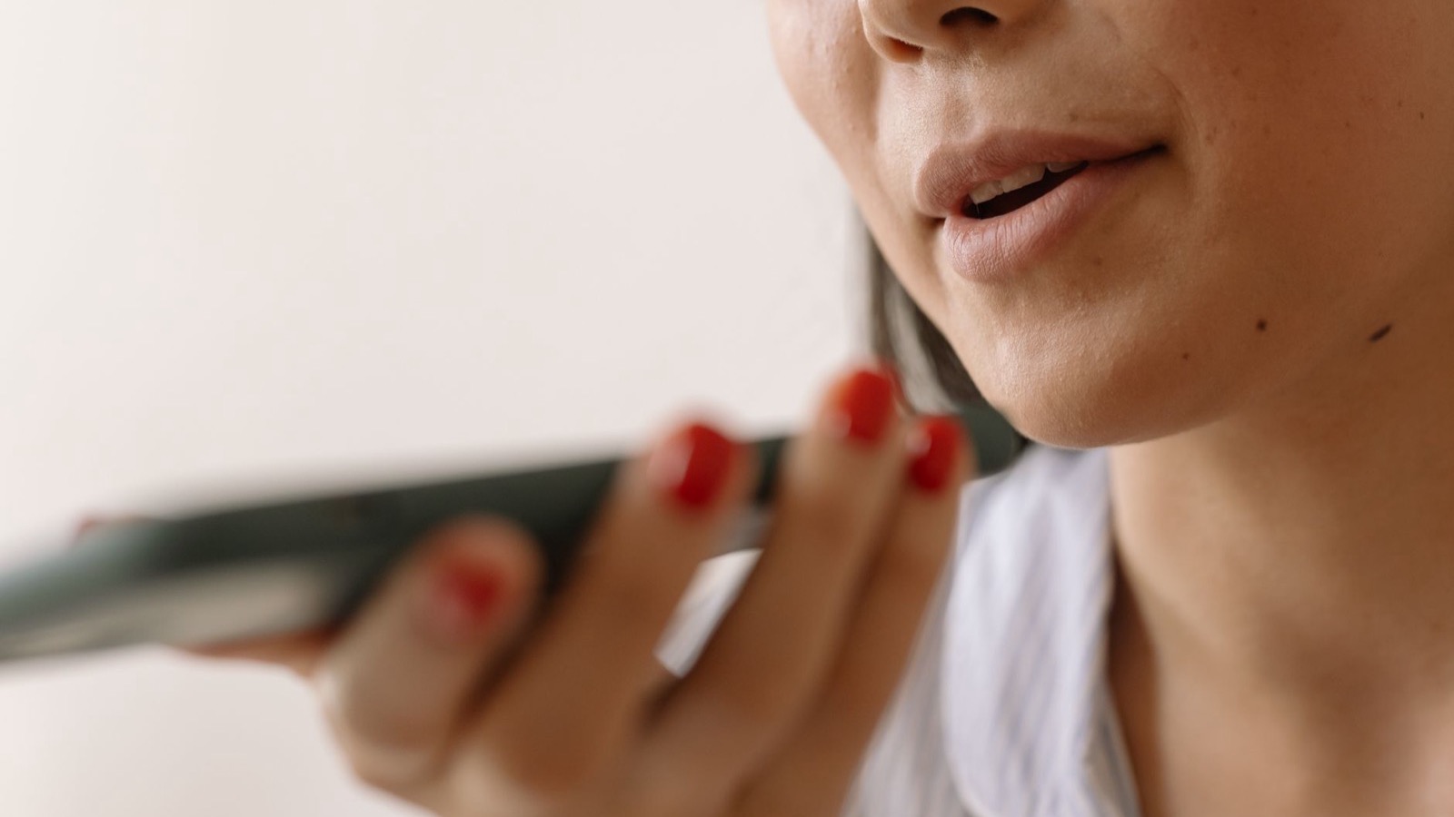 Woman speaking a voice command into a smartphone