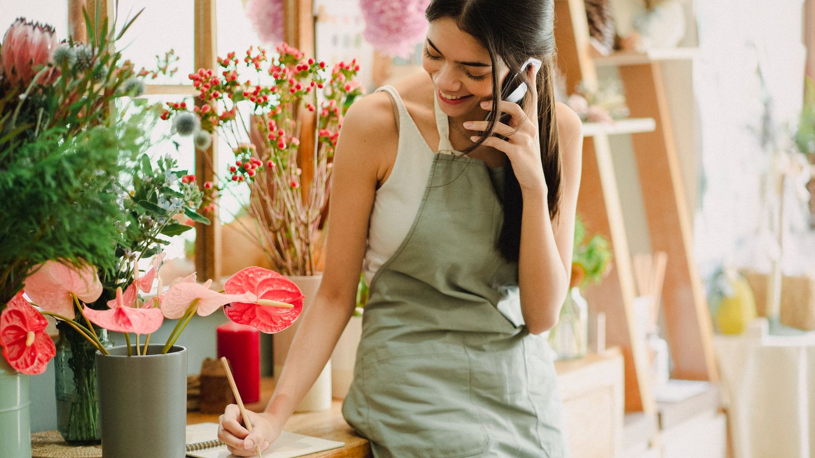 AfDB and AXIAN target 34,000 women-led businesses 1 A small-business owner using a mobile phone